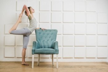 woman stretching armchair