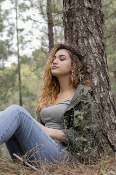 medium shot woman sitting near tree