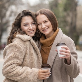 medium shot women with coffee outdoors