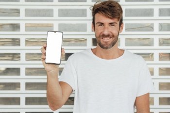 happy man holding cellphone with mock up