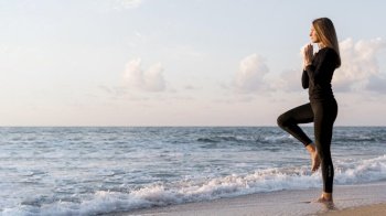 woman meditating beach with copy space