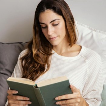 front view woman reading book home