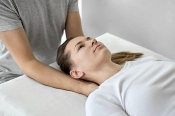male therapist undergoing physical therapy with female patient 2