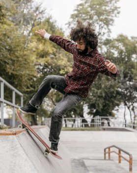 man having fun with skateboard city park