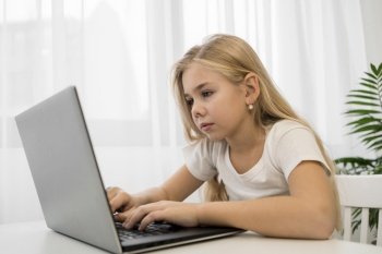 portrait little girl using laptop