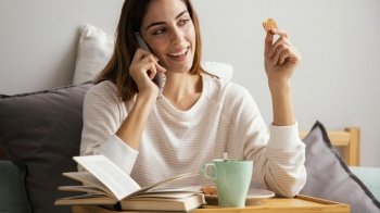woman having breakfast talking phone home