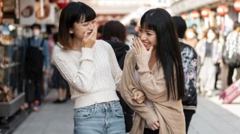 pretty asian girls laughing together