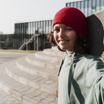teenager with skateboard park taking selfie