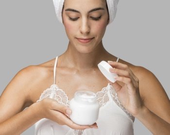 front view lady holding open container cream