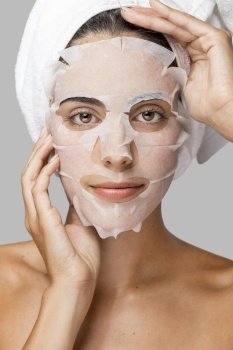 front view woman with face beauty mask