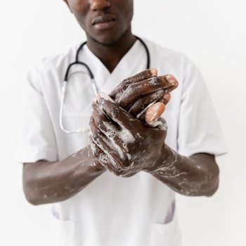 professional young doctor washing hands close up