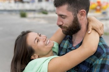 smiley couple hugging outdoors