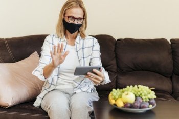 woman with smartphone cotton mask home during quarantine