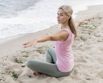 beautiful blonde woman doing yoga beach 2