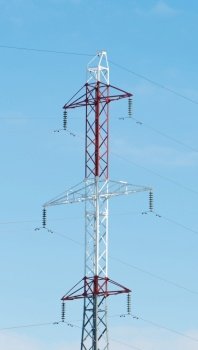 high voltage tower against the blue sky. post electric, insulated