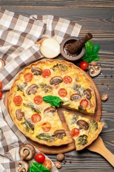 Traditional french Baked homemade quiche pie on wooden cutting board. Traditional french Baked homemade quiche pie on wooden board