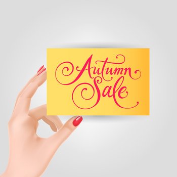 Hand holding card with autumn sale lettering. Autumn offer or sale advertising design. Handwritten text, calligraphy. For leaflets, brochures, invitations, posters or banners.