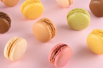 Macarons on pastel background. Classic french macaroons with different tastes.