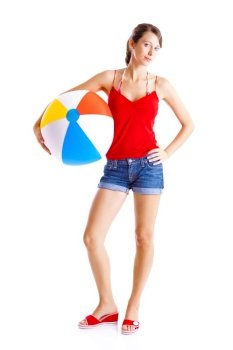 Beautiful young woman posing with a beach ball