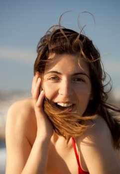 Outdoor portrait of a beautiful happy young woman on the beach