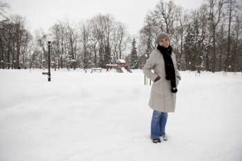 Beautiful woman enjoying a winter day full of snow