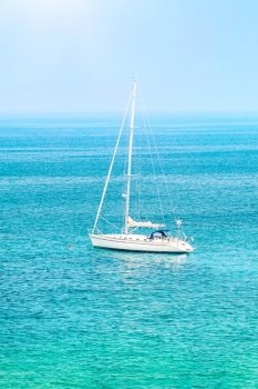 Sailboat among beautiful blue sea in sunny day, summer traveling on the water transport, luxury summertime vacation