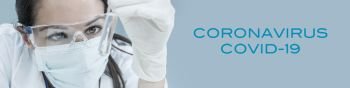 Panoramic web banner panorama header of female medical or research scientist or doctor wearing face mask looking at a test tube of clear solution in a Coronavirus COVID-19 lab or laboratory