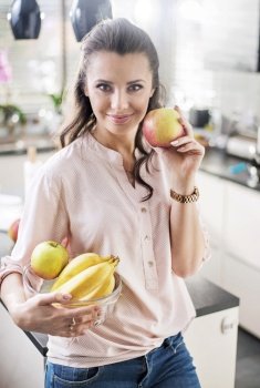Brunette, young woman holding a fruit bowl