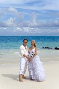 The groom and the bride on the tropical beach.