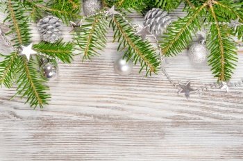 Christmas decorations, pine cone and fir branch on a white wooden background