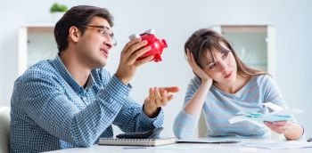 Young couple looking at family finance papers. The young couple looking at family finance papers