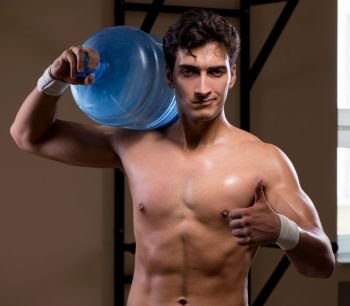 The muscular ripped man with big water bottle. Muscular ripped man with big water bottle