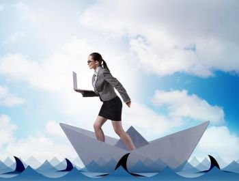 The businesswoman riding paper boat ship in business concept. Businesswoman riding paper boat ship in business concept