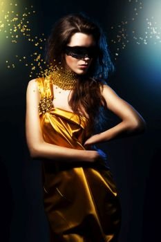 woman in yellow dress and black mask with broken jewelry