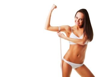 Woman measuring her muscles on white background