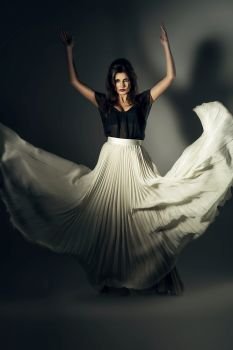 attractive woman in flying long skirt