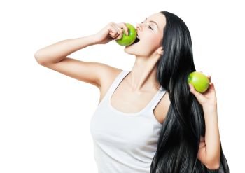 woman with green apples and long hair on white background