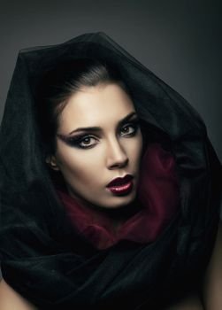 portrait of passionate woman in black hood