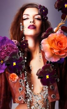 erotic woman with silver accessory in flowers