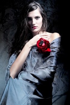 woman in grey fabric with red rose
