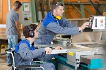 disabled man working in woodworking factory