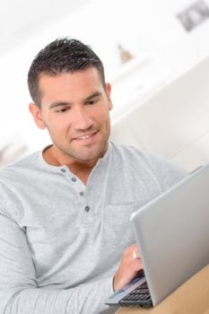 middle-aged man working from home on laptop computer
