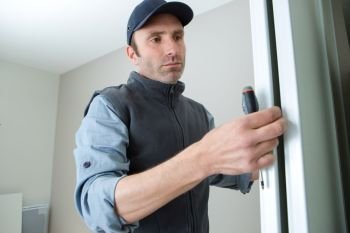 male lockpicker fixing door handle at home