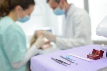 a dentist starts to examine a patient