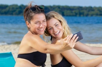 two women do selfie on vacation on the beach