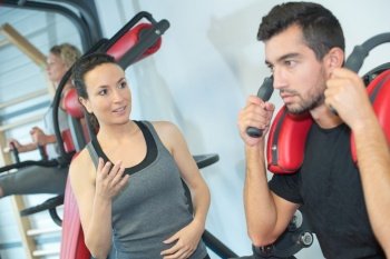 attractive woman and man exercising at gym