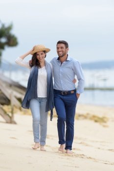 mid-adult couple walking on beach