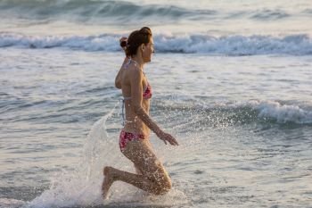 girl jumping on sea wave