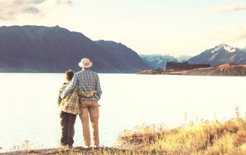 couple in beautiful mountains lake, New Zealand, Tekapo lake