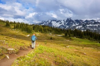 Hiking man in the mountains  outdoor active lifestyle travel adventure vacations summertime. Hike concept
